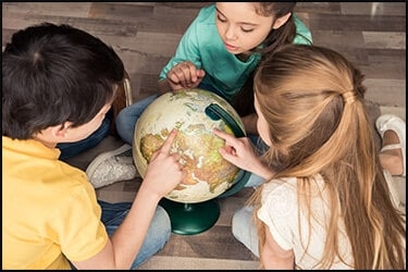 Kids pointing on a globe