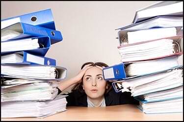 Girl with a lot of work folders